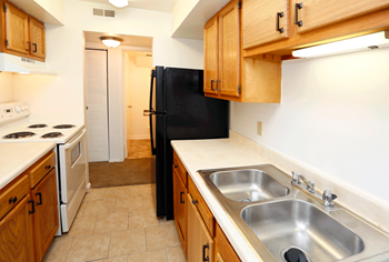 a kitchen with wooden cabinets and white appliances